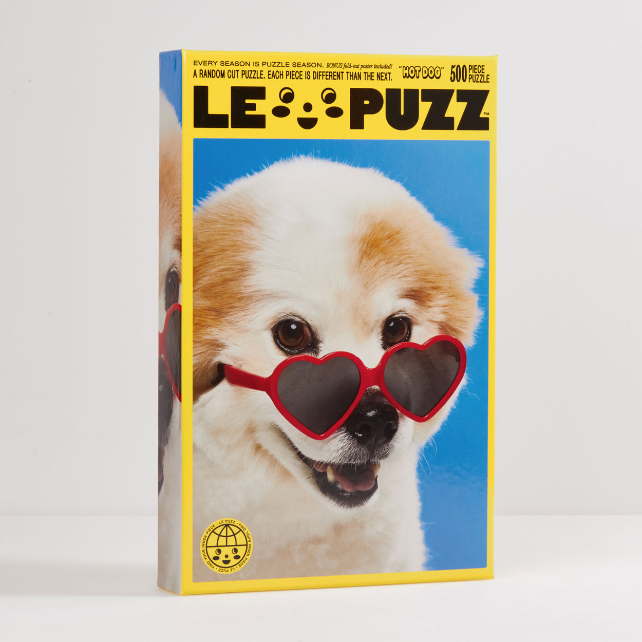 Hot Dog Puzzle | Le Puzz | 500 Pieces: Cream Fluffy Dog with Heart Sunglasses Puzzle. Hot Dog features our furry fwend Bucky! When we met Bucky we knew he’d make a perfect puzzle pal. He stole our hearts with his teeny grin and heart shaped sunglasses.